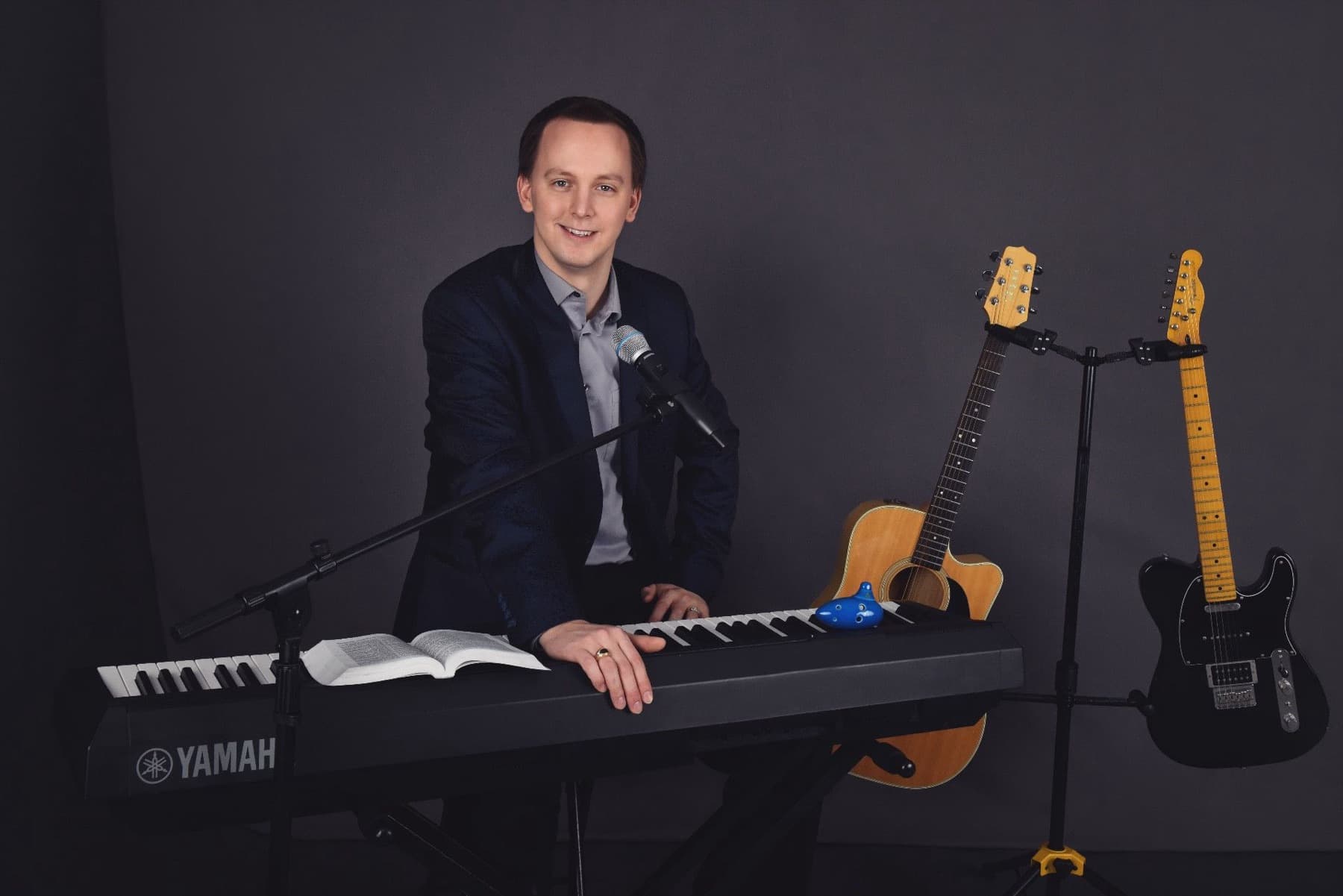 Stephen Forester with keyboard, guitars, and Bible